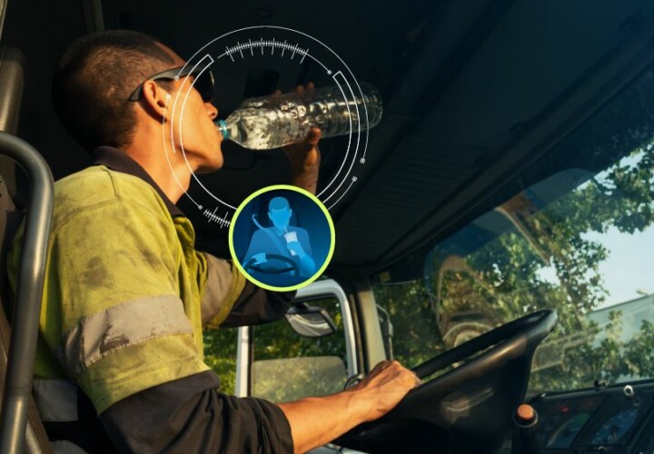man distracted whilst driving because he is drinking water