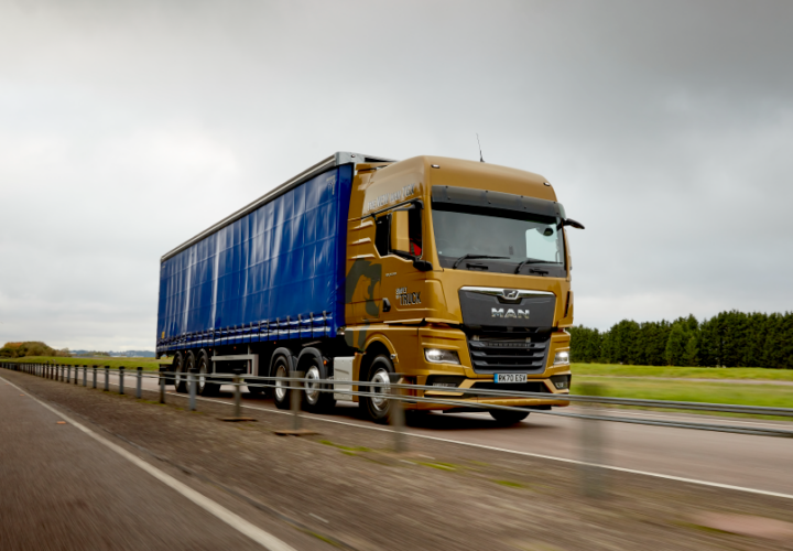 a lorry driving on the road using transport management system (TMS)